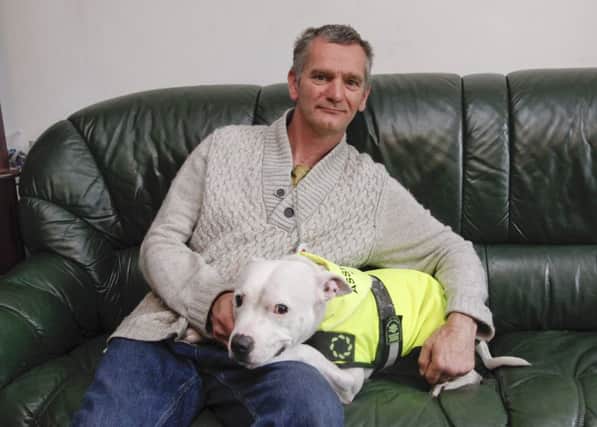 James Bjorkly and Eko, a Staffie assistance dog.