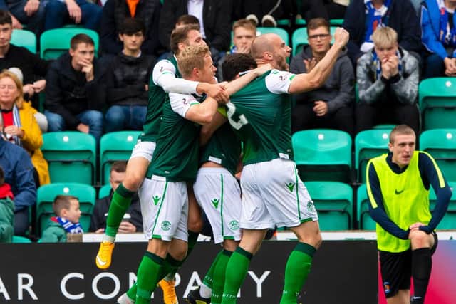 Hibs skipper David Gray is mobbed by his team-mates after putting the Easter Road side two up against Kilmarnock