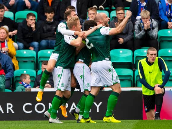 Hibs skipper David Gray is mobbed by his team-mates after putting the Easter Road side two up against Kilmarnock