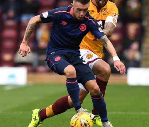 Jimmy Dunne holds off Motherwell's Peter Hartley