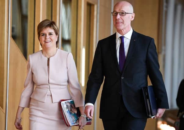 First Minster Nicola Sturgeon and Deputy First Minister/Education Secretary John Swinney arrive at the Scottish Parliament. Picture: Getty Images)