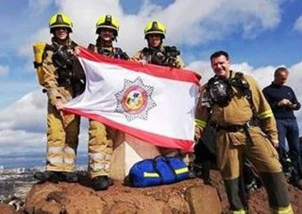 Volunteers from Scottish Charity International Fire And Rescue Association were undertaking a sponsored climb of Arthur's Seat when they were asked to assist a Tourist who had taken unwell. Picture: Contributed