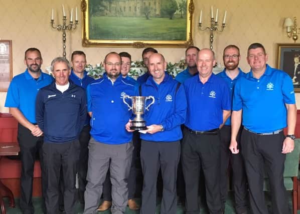 Turnhouse team manager Moray Hanson and his triumphant squad show off the trophy at Royal Musselburgh