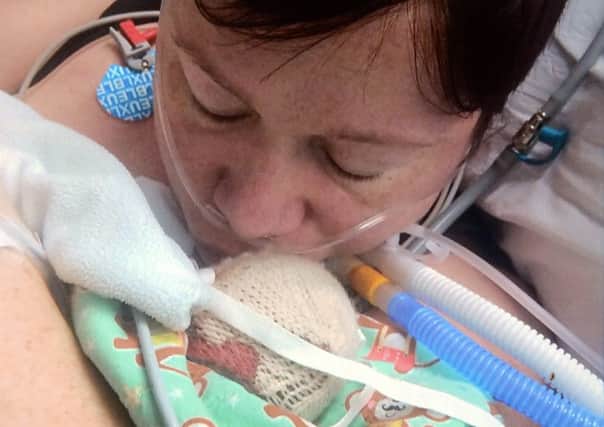 Mum Amy Homes with her son Aiden in hospital. Picture: Jon Savage