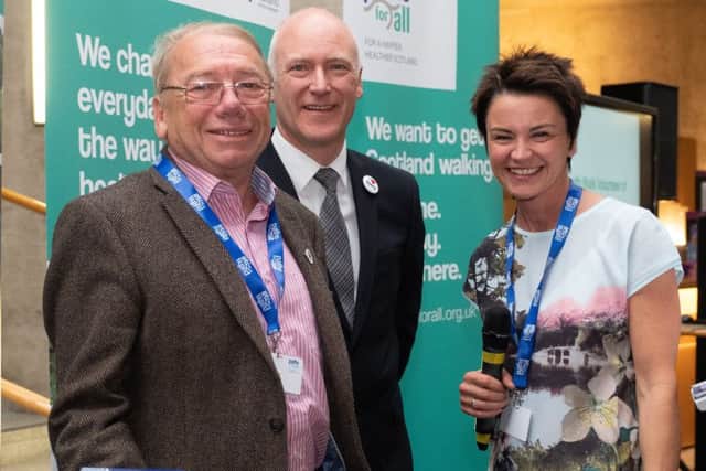 Tony with his award, watched by Minister for Public Health, Sport and Wellbeing Joe FitzPatrick