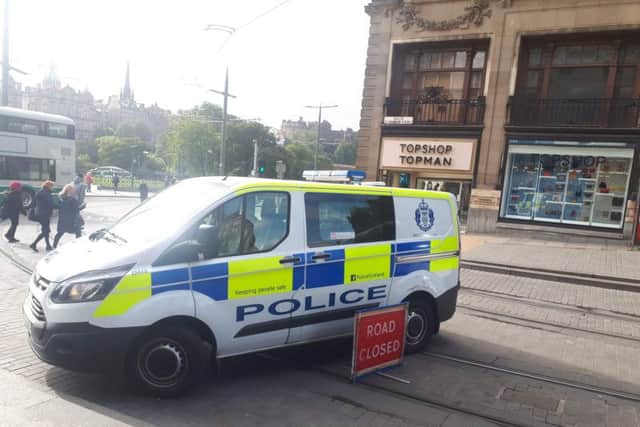 At least five police officers are at the scene on Princes Street