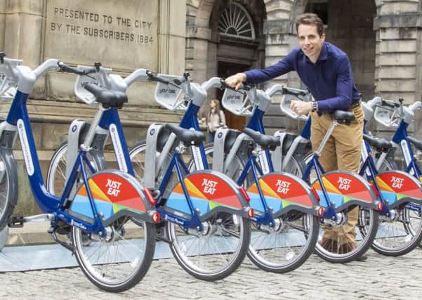 Edinburgh long-distance cyclist Mark Beaumont helps launch the new Just Eat hire bikes. Picture: SWNS