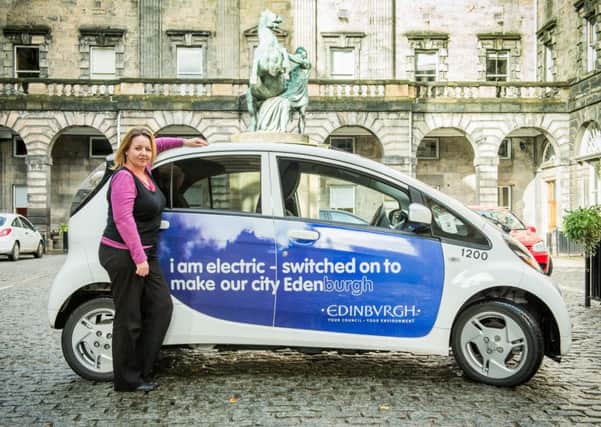 Environmental Health Officer Angela Davis with one of the elecdtric vehicles at the City Chambers. Picture: Ian Georgeson