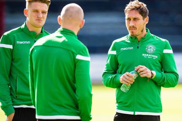 Mark Milligan, right, makes his first start for Hibs. Picture: SNS Group