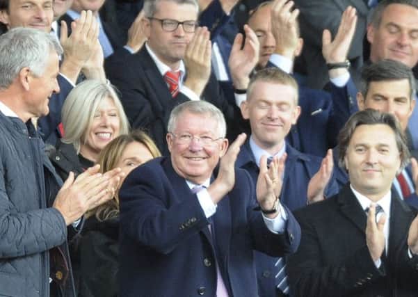 Former Manchester United manager Alex Ferguson applauds as he takes his seat on the stands before the English Premier League soccer match between Manchester United and Wolverhampton Wanderers. Picture; AP
