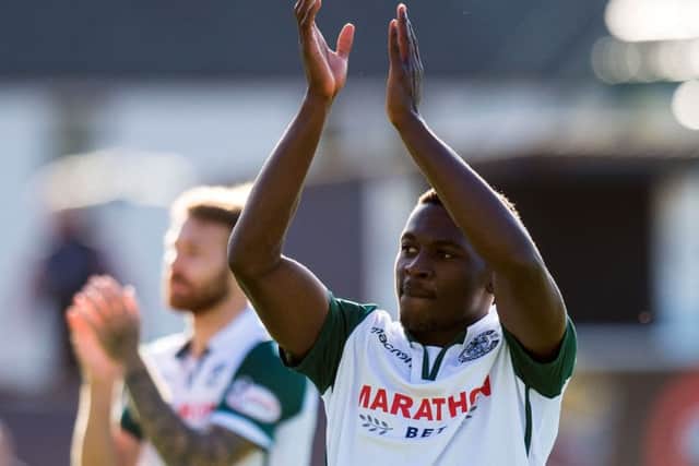 Thomas Agyepong salutes the travelling Hibs support. Picture: SNS Group
