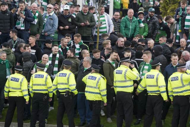 Celtic fans face a line of police officers separating them from Rangers supporters. Picture: John Devlin