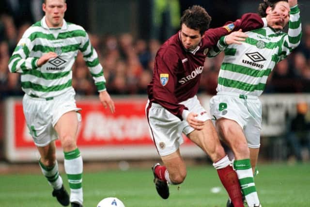 Stephane Adam holds off Celtic's Craig Burley during a 1-1 draw at Tynecastle in February 1998