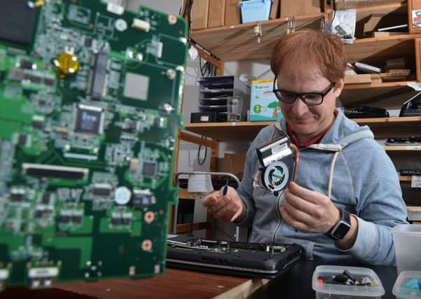 Mario Di Filippo repairs a laptop for the Syrian refugee programme at Edinburgh Remakery. Picture: Jon Savage