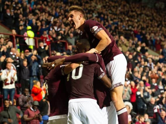 Hearts players and fans celebrate on an electric night at Tynecastle.