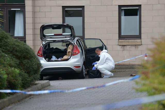 Forensics officers scour the scene. Picture: Jon Savage