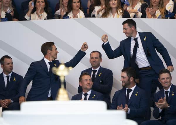 Thorbjorn Olesen, left, and Rory McIlroy bump hands during the opening ceremony. Picture: Tom Russo