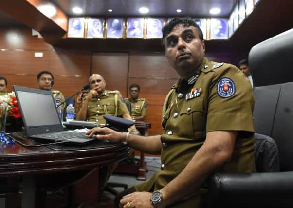 Sri Lanka police chief Pujith Jayasundara, right, at police  headquarters in Colombo. Photograph: Ishara S Kodikara/Getty