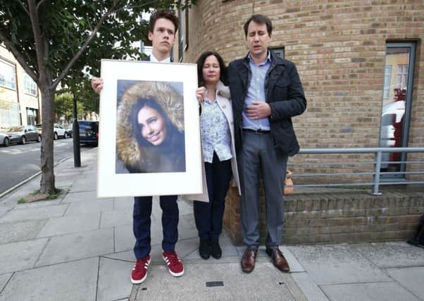 Nadim and Tanya Ednan-Laperouse, with their son Alex, holding a picture of Natasha outside West London Coroners Court, following the conclusion of the inquest. Picture: Jonathan Brady/PA Wire
