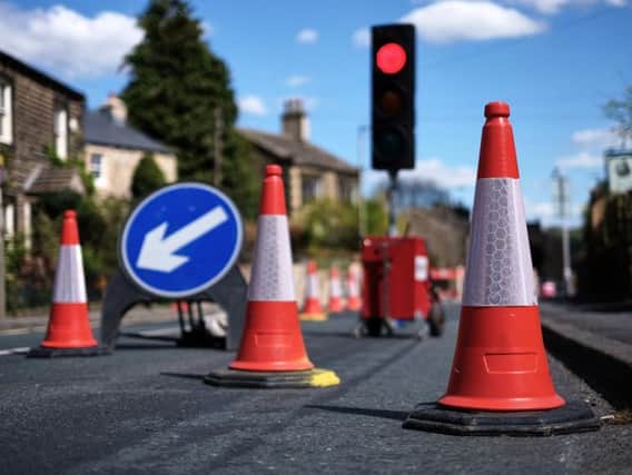 Temporary traffic lights and cones on a street. Picture: Shutterstock, mattxfoto