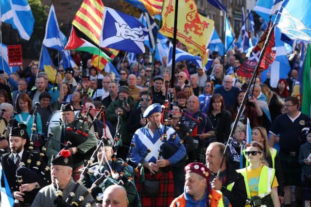 Pipers play as the All Under One Banner marchers make their way down the Royal Mile. Picture: PA