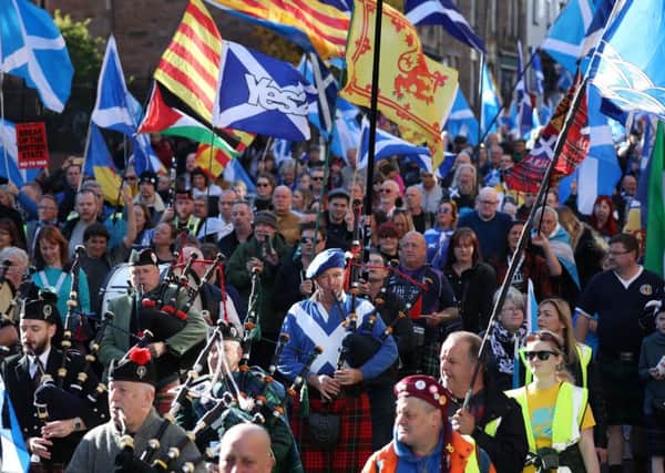 Pipers play as the All Under One Banner marchers make their way down the Royal Mile. Picture: PA