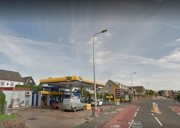 A cashier was held up at knifepoint at the service station on Belhaven Road.