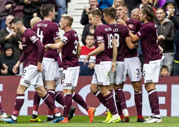 Hearts sit top of the league after a quite remarkable turnaround in squad and style. Picture: SNS/Roddy Scott