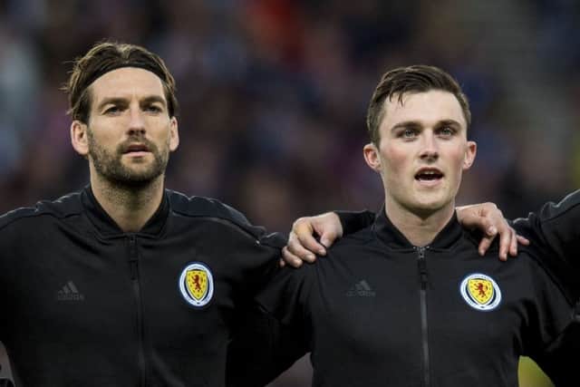 John Souttar, centre, has been tipped to have a long Scotland career by fellow internationalist Charlie Mulgrew, left. Pic: SNS