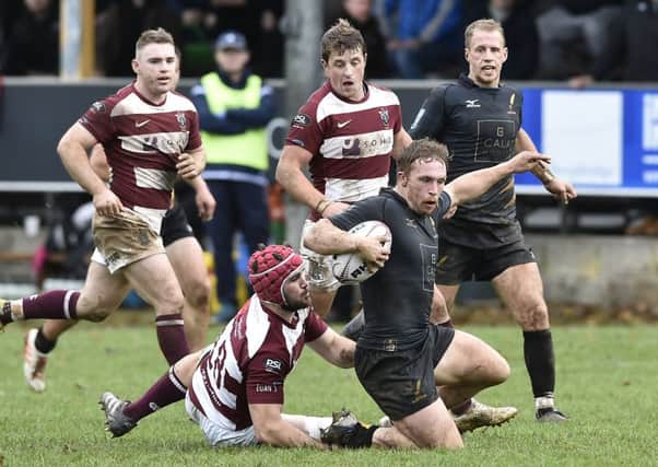 Thomas Gordon of Currie is tackled by Rory Hutton of Watsonians. Pic:
 Neil Hanna