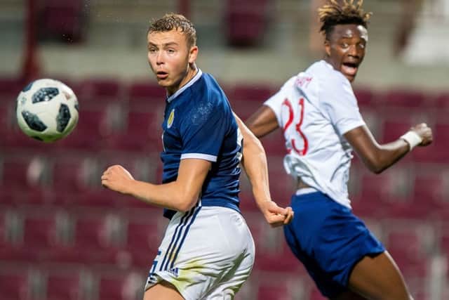 Hibs' Ryan Porteous battles with Tammy Abraham as Scotland Under-21s lost to England. Pic: PA