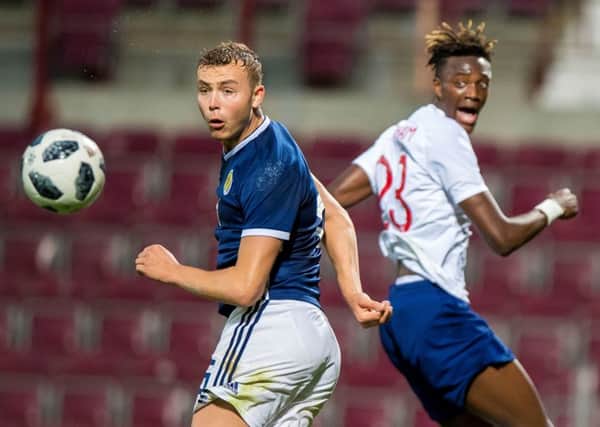 Hibs' Ryan Porteous battles with Tammy Abraham as Scotland Under-21s lost to England. Pic: PA