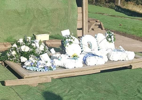 Flowers and messages of support for the family.