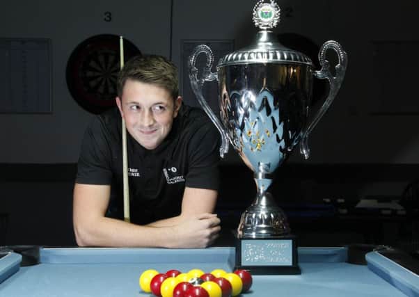Ross Fernie cannot takes his eyes off the Scottish Open Pool Trophy. Pic: Alastair Linford