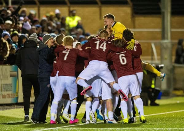 The Linlithgow team of 2016 celebrate knocking Forfar Athletic out of the Cup