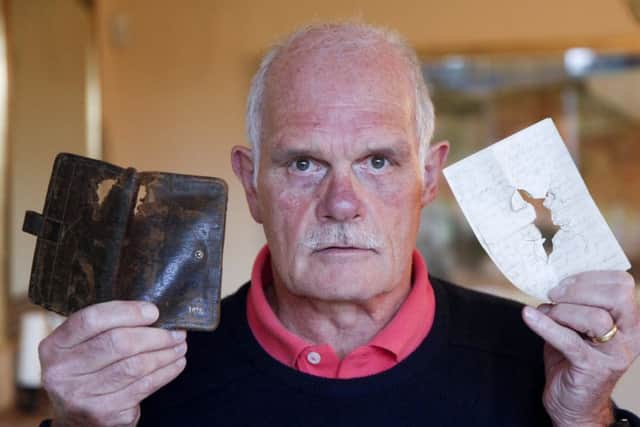 Keith Miller with letters and wallet showing the bullet hole that belonged to his grandad who was killed in WW1. Picture: Alistair Linford