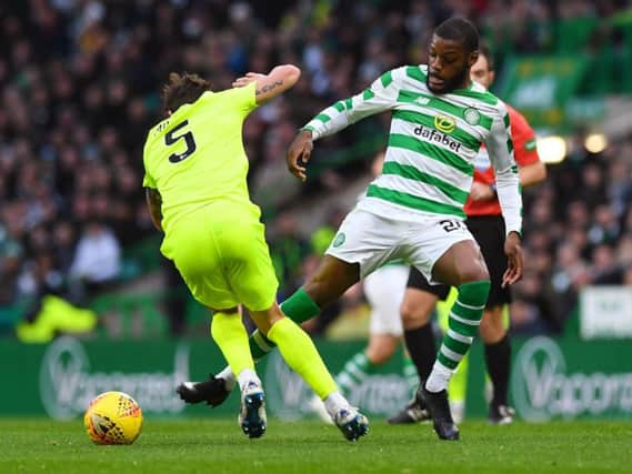 Hibs midfielder Mark Milligan tussles with Olivier Ntcham, scorer of Celtic's second goal at Parkhead this afternoon