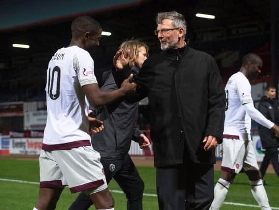 Hearts manager Craig Levein and Arnaud Djoum enjoy the victory at Dens Park.