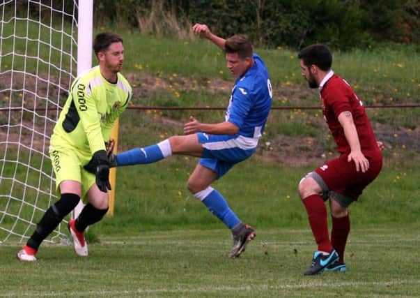 Penicuik striker Wayne McIntosh proves to be a handful for Arniston (picture: Jim Dick)