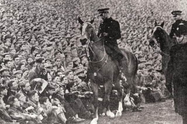 Mounted police keep an eye on the crowds at the Edinburgh derby in January 1950 at Easter Road. A record attendance of more than 65,000 fans saw Hearts beat Hibs by two goals to one (Photo: JP)