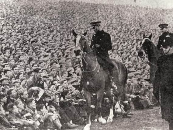Mounted police keep an eye on the crowds at the Edinburgh derby in January 1950 at Easter Road. A record attendance of more than 65,000 fans saw Hearts beat Hibs by two goals to one (Photo: JP)