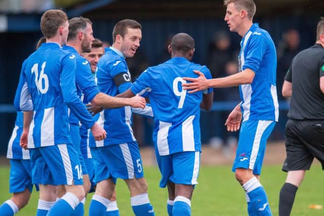 Lumbert Kateleza (No.9) is congratulated after scoring the third
