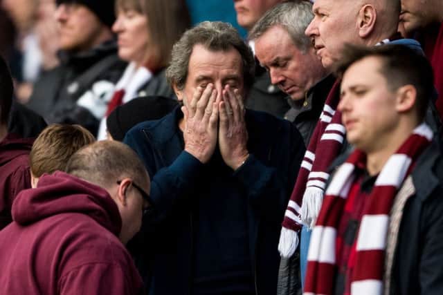 Hearts fans can't bear to look as their side goes down 3-0 to Celtic. Picture: SNS Group