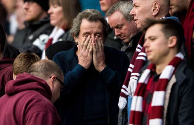Hearts fans can't bear to look as their side goes down 3-0 to Celtic. Picture: SNS Group