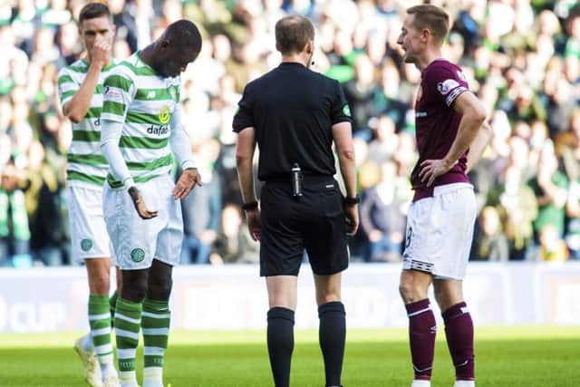 Willie Collum speaks to Steven MacLean and Eboue Kouassi after the pair clashed. Picture: SNS Group
