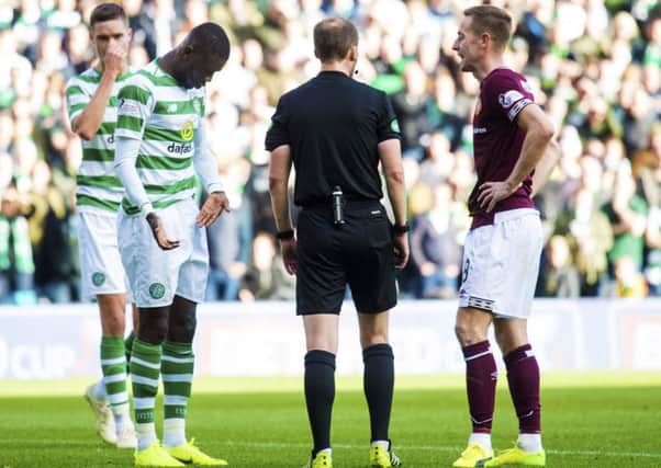 Willie Collum speaks to Steven MacLean and Eboue Kouassi after the pair clashed. Picture: SNS Group