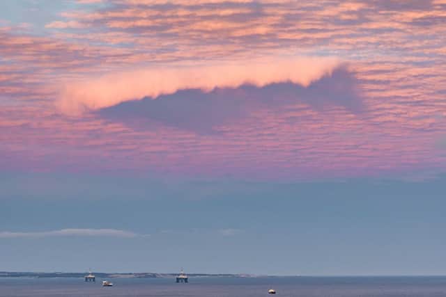 A shark shaped cloud captured in a sunset over the Firth of Forth by Paul Adams from Kirkcaldy in Fife. Picture: SWNS