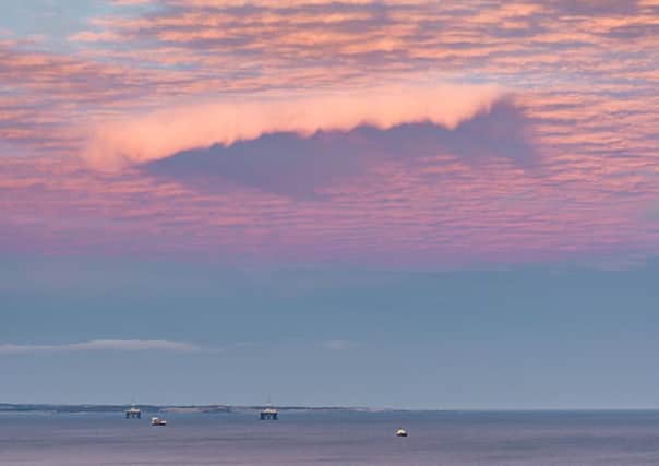 A shark shaped cloud captured in a sunset over the Firth of Forth by Paul Adams from Kirkcaldy in Fife. Picture: SWNS