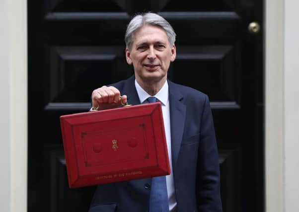 Chancellor of the Exchequer Philip Hammond holds the budget box up to the media.  (Photo by Dan Kitwood/Getty Images)