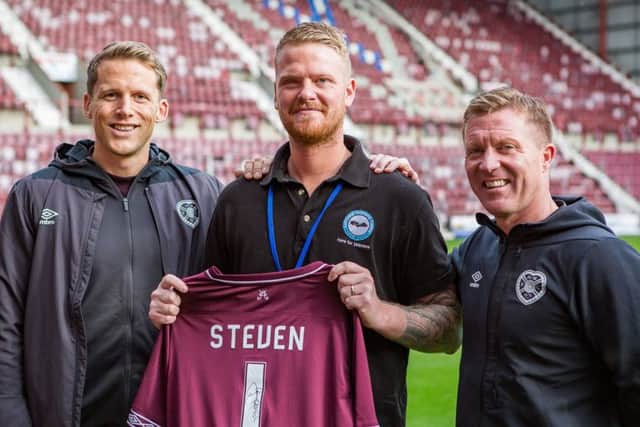 Steven meets club captain Christophe Berra, left, and legend Gary Locke at Tynecastle